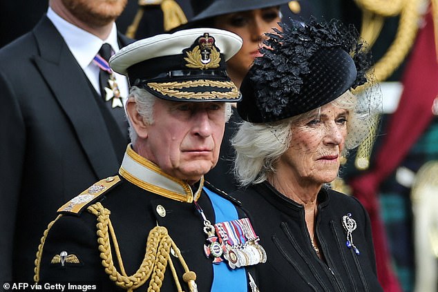 King Charles III and Queen Camilla at the late Queen's funeral. A source claimed that 'Charles made it very, very clear Meghan would not be welcome' at Balmoral