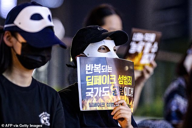 Activists hold posters reading 'Repeated deepfake sex crimes, the state is an accomplice too' during a protest against deepfake porn in Seoul on August 30, 2024