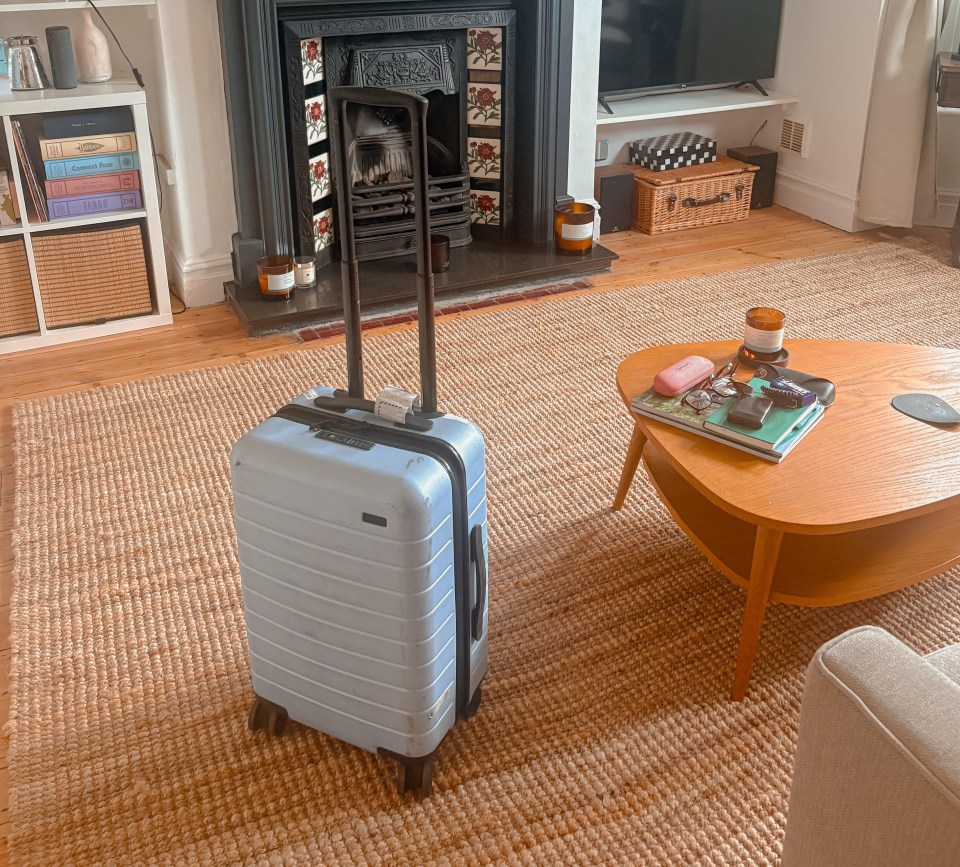Light blue suitcase in living room.
