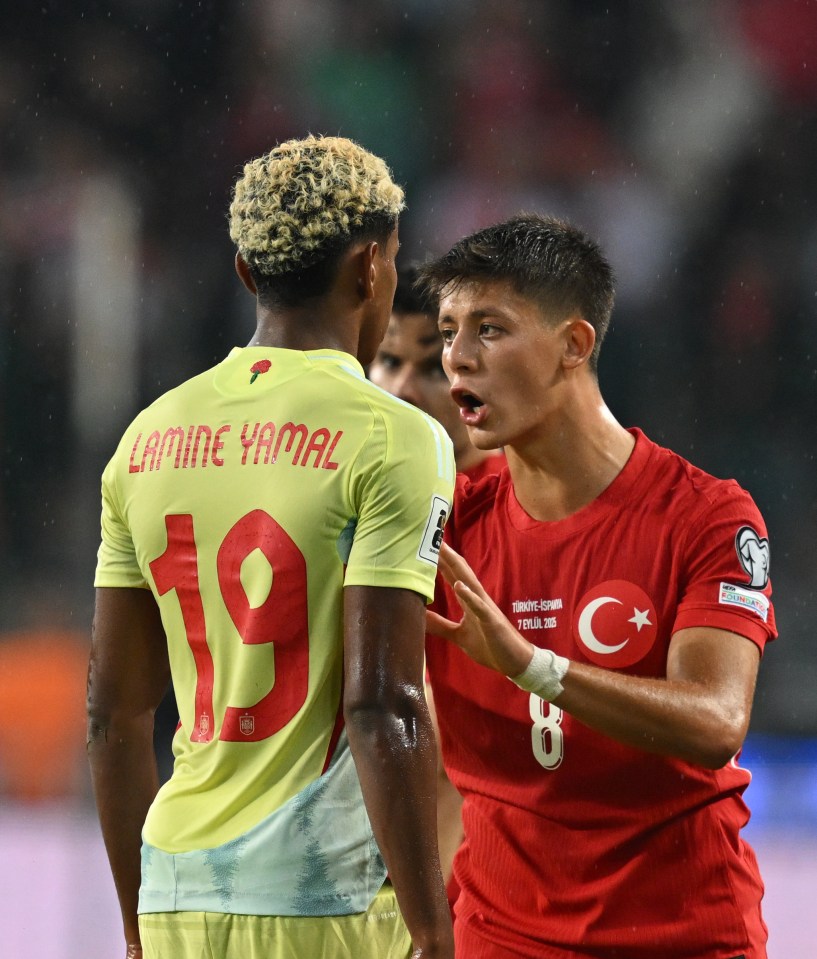 Lamine Yamal of Spain and Arda Guler of Türkiye arguing during a soccer match.