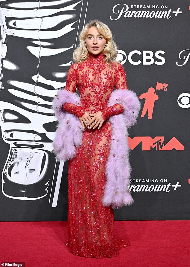 Earlier in the night Sabrina sizzled in a skintight glittery red lace gown by Valentino, paired with a lavender feather boa, as she arrived at the bash ahead of her performance