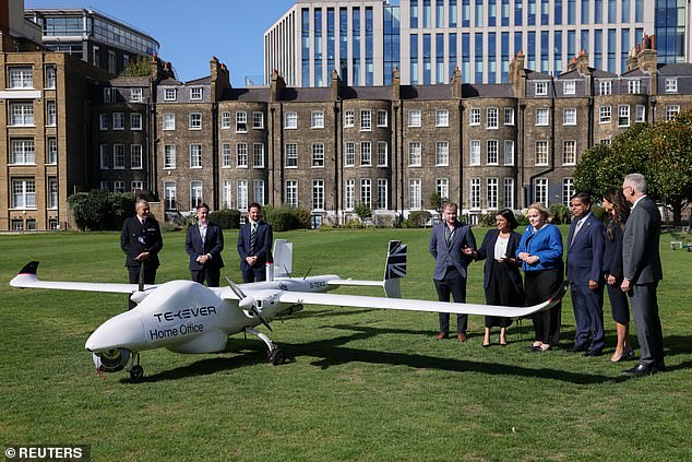 The Five Eyes summit delegates stand next to a drone on the grounds of the Honourable Artillery Company in central London