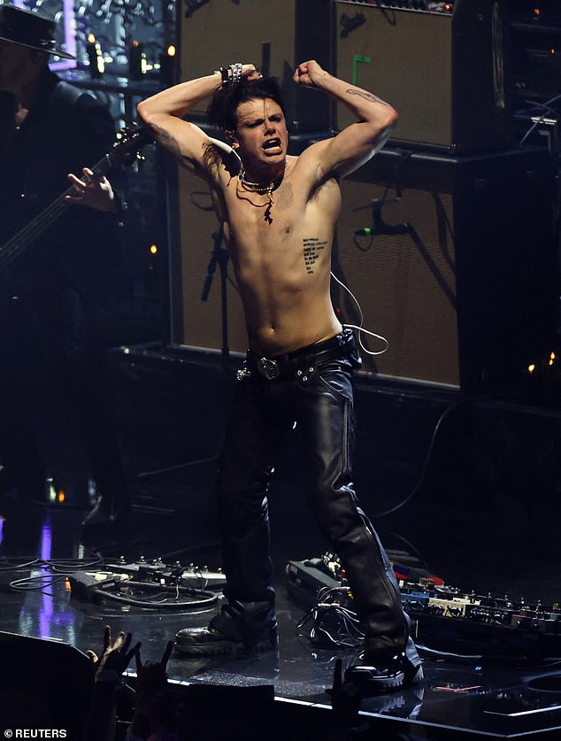 Yungblud showed off his abs by ditching his jacket and performing some bizarre poses for the cameras (Seen performing on stage)