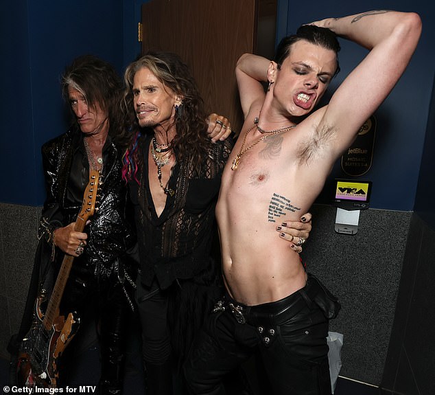 Again baring his tattooed chest and an array of gold chains, Yungblud lifted his arms in the air as he dragged his hands through his hair