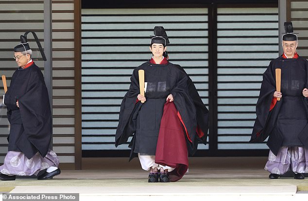 Hisahito, wearing ancient ceremonial costume, leaves for a ceremony by a carriage at the Imperial Palace in Tokyo Saturday
