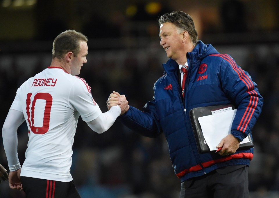Wayne Rooney and Louis van Gaal shaking hands after a soccer match.