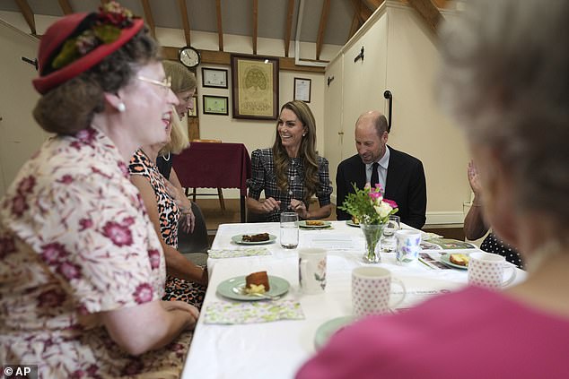 The couple were all smiles as they enjoyed hearing from members at the WI - an organisation close to Elizabeth's heart