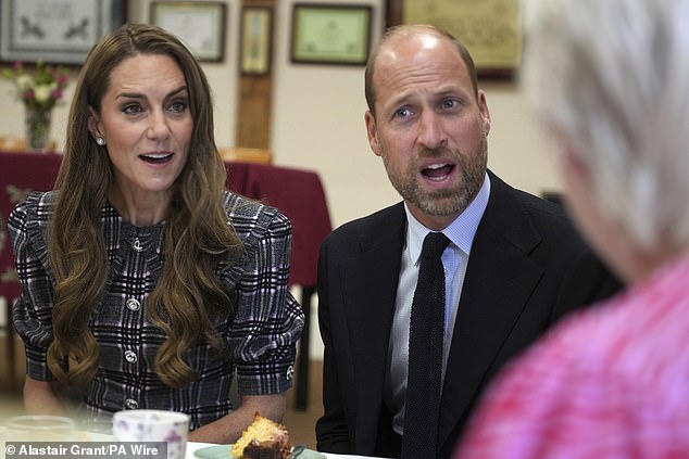 The pair were very animated as they chatted with others over tea and cake - in a visit commemorating the late Queen