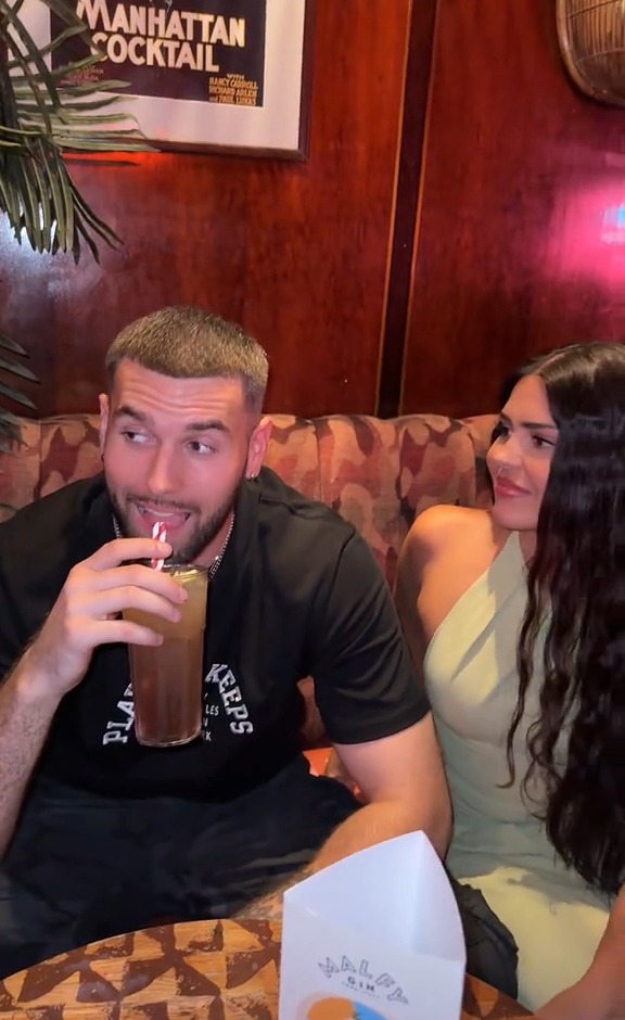 Emma Munro and Zach Noble sitting together at a bar.