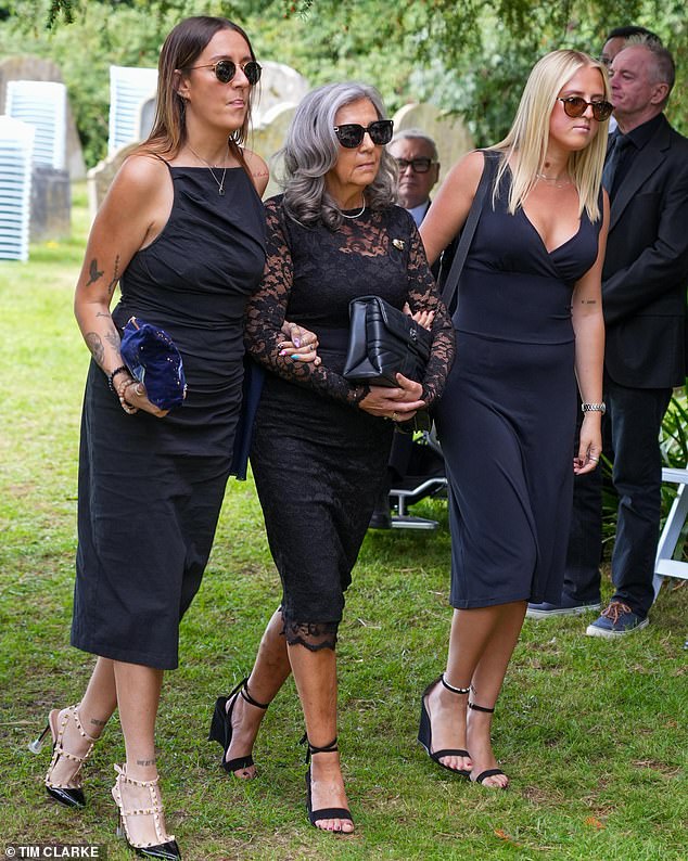 James' heartbroken widow Nadine Lamon Brown (L) was helped by relatives to take her seat for the service