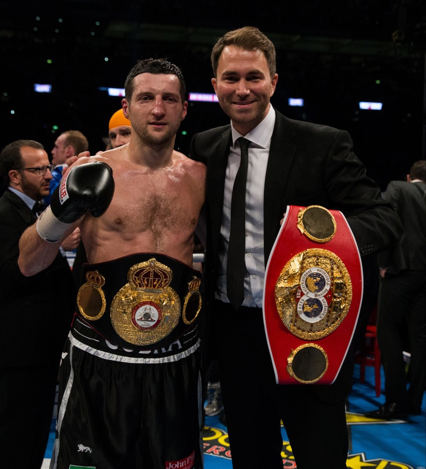 Carl Froch and Eddie Hearn with boxing championship belts.