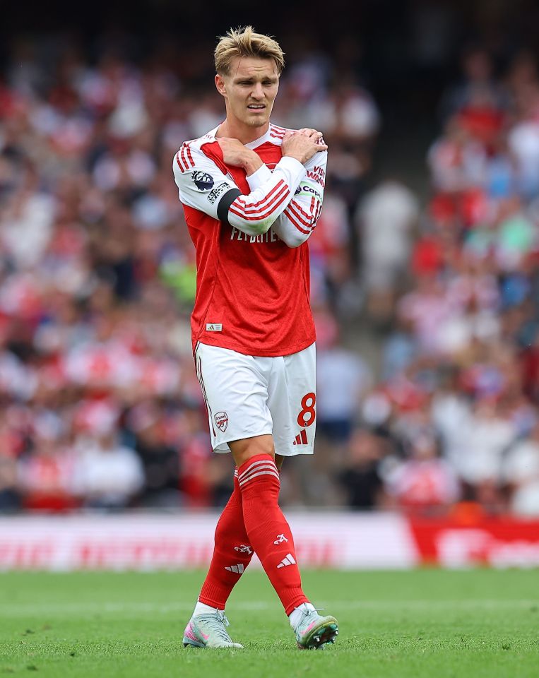 Martin Odegaard of Arsenal holding his shoulders.