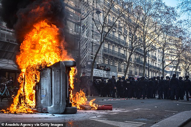 Clashes with riot police take place during a rally against French President's plan to raise the legal retirement age from 62 to 64 in Paris, on February 11, 2023