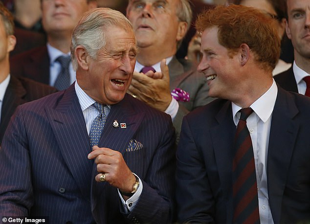 Harry laughs with his father during the opening ceremony of the 2014 Invictus Games
