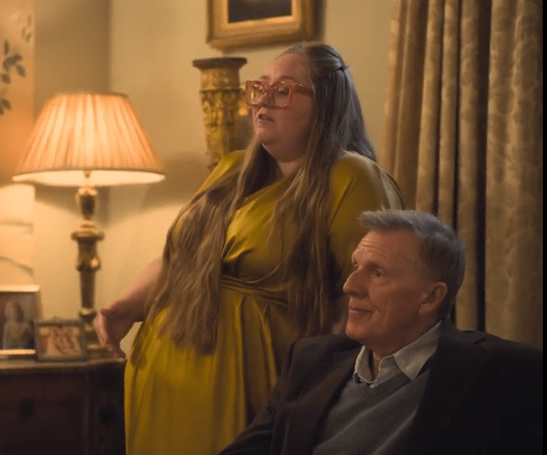 A woman and man sitting in a room.