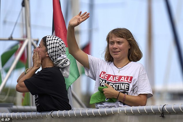 Swedish climate activist Greta Thunberg waves from a boat taking part in a civilian flotilla bound for Gaza, aiming to break the Israeli blockade