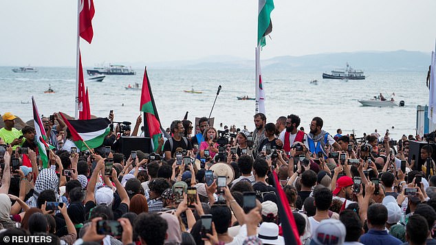 Pictures from the Sidi Bou Said port in Tunisia on Sunday showed huge crowds had gathered around the 22-year-old as she docked in their port on route, she said: 'We all know why were are here'