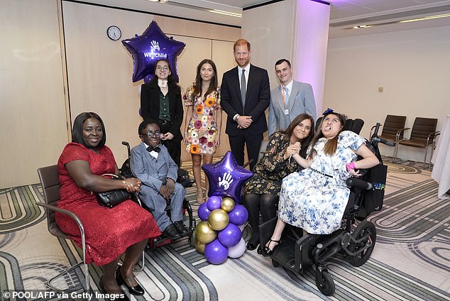 The Duke of Sussex poses with previous WellChild award recipients