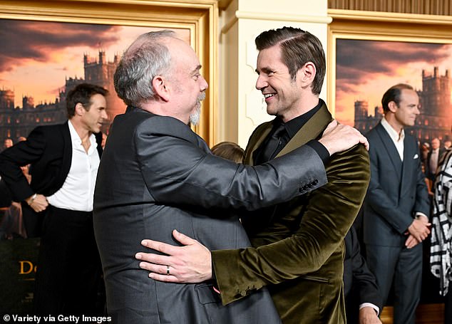 An animated Paul Giamatti and Allen Leech warmly greeting each other on the red carpet
