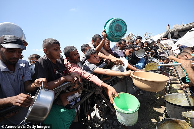 Palestinians carrying pans and bowls forms a crowd to receive food aid provided by charity organisations in Gaza City, Gaza on September 3, 2025