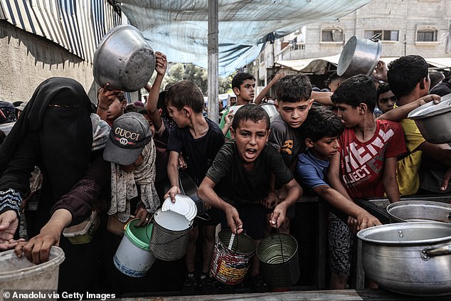 A large number of Palestinians, including children, gather in order to get food, in Nuseirat Refugee Camp, central Gaza, on September 3, 2025