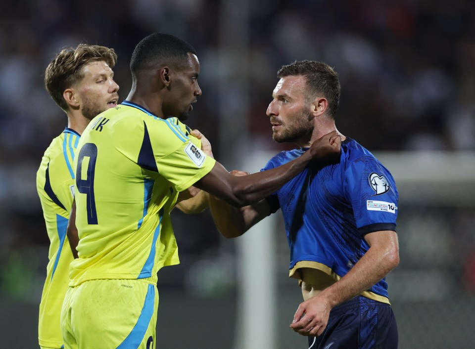 Sweden's Alexander Isak and Kosovo's Fidan Aliti clashing during a soccer match.