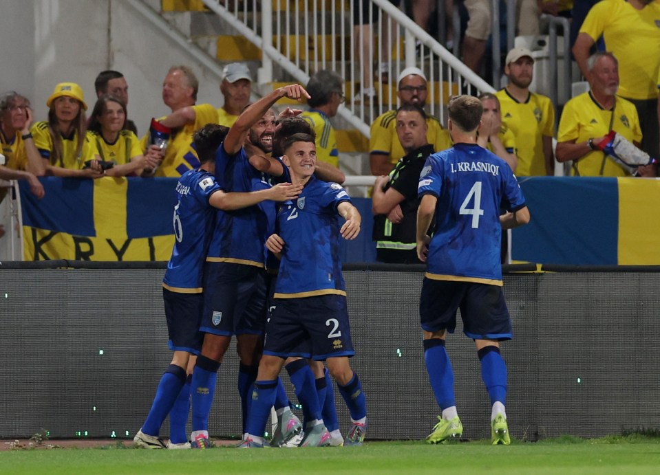 Kosovo soccer players celebrating a goal.