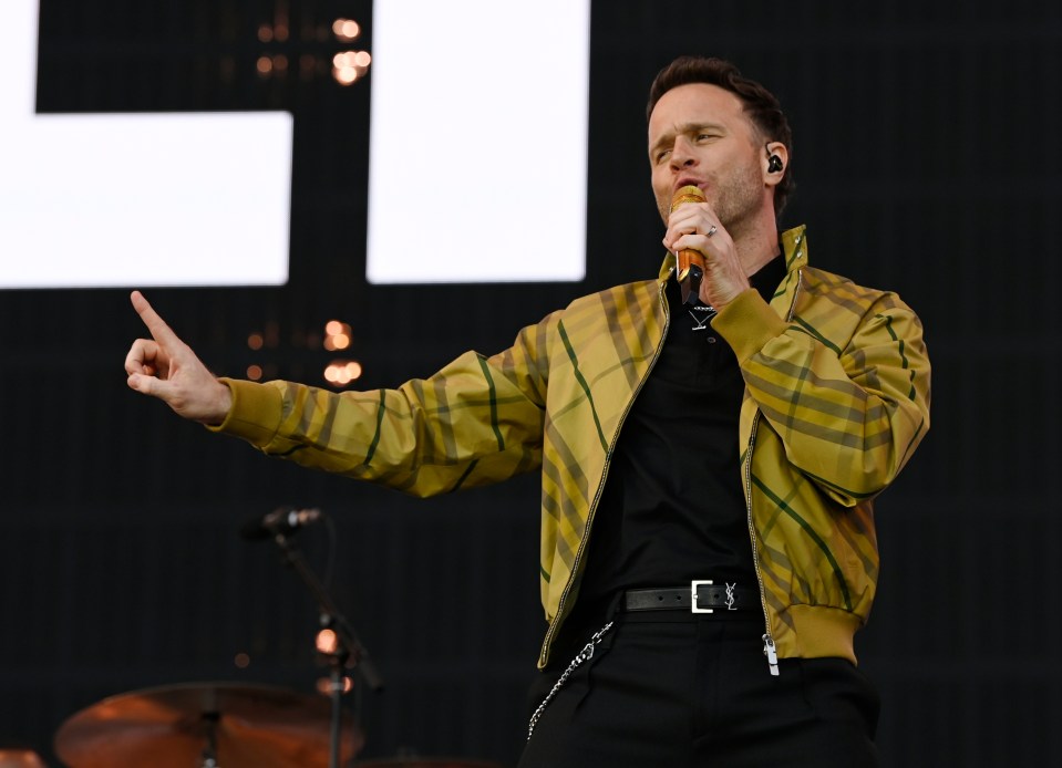 Olly Murs performing on stage.
