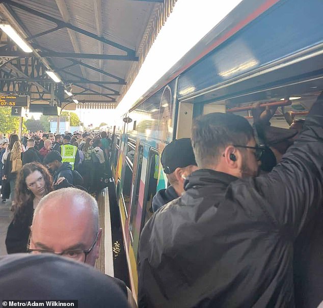 Many workers risked the doors closing on them as they pushed onto the overground service