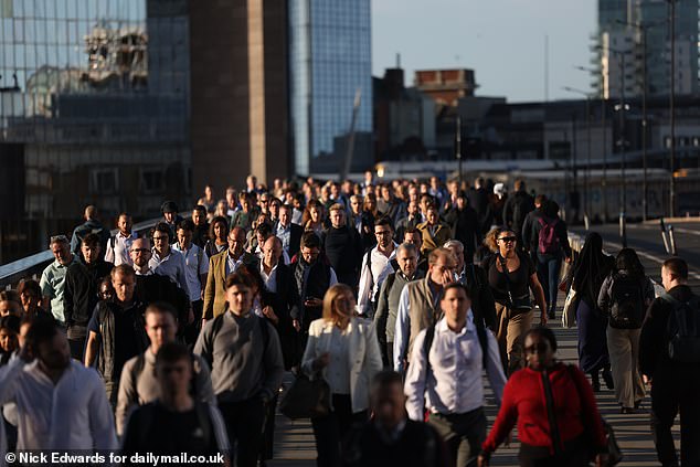 Swarms of commuters were seen walking over London Bridge on Monday amid travel chaos