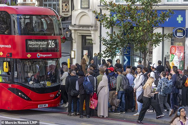 Commuters wait at a bus stop near Liverpool Street Station in central London as the Tube strike continues
