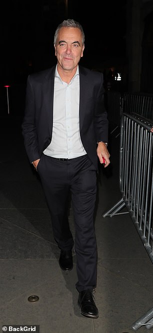 James cut a cool figure in a dark suit
