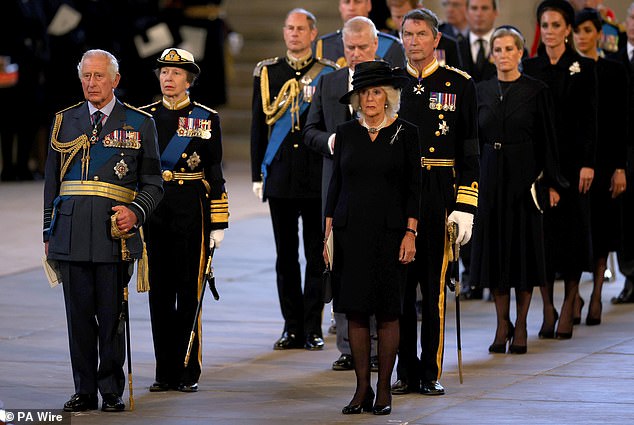 Queen Elizabeth II's family stand behind her coffin in Westminster Hall, London, where it would lie in state ahead of her funeral