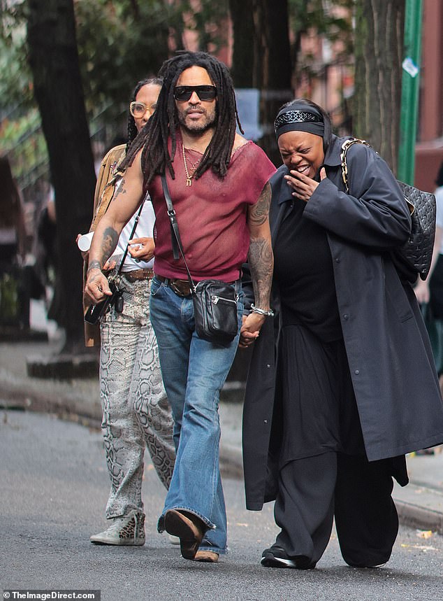 As they made their way to the restaurant, Lenny held hands with another member of their party who was in fits of giggles while they crossed the street