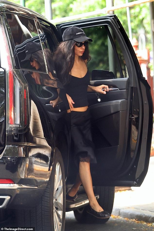 She emerged from a huge car while rocking a baseball cap