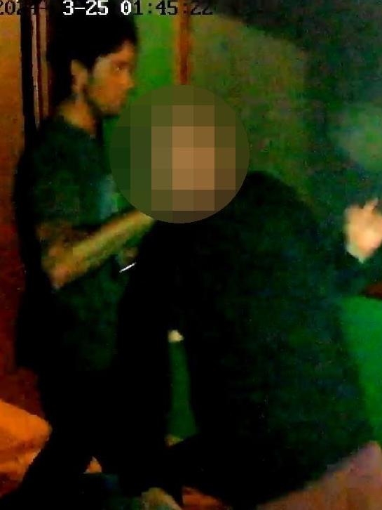 a shirtless man wearing a neck brace is being pushed in a wheelchair by a nurse
