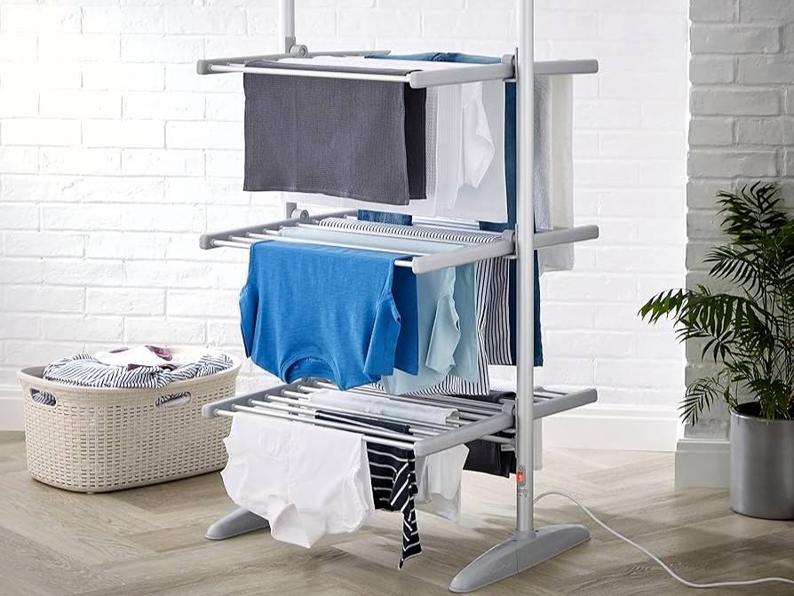 Three-tier heated clothes airer with clothes drying.