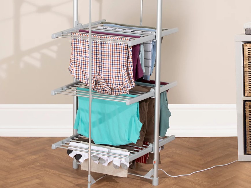 Three-tier heated clothes airer with clothes drying on it.