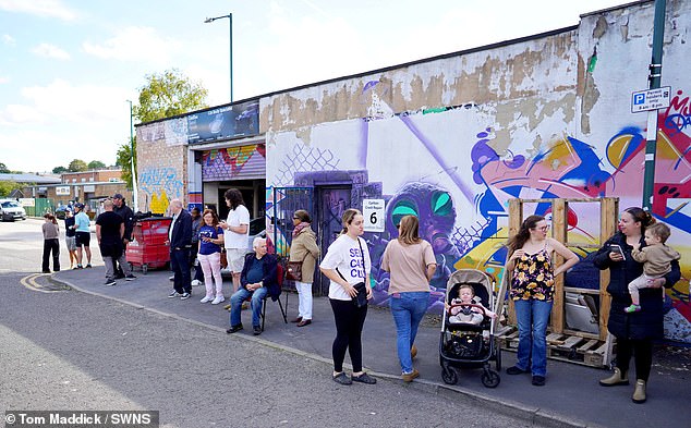 People gather to watch Harry arrive at the recording studio in Nottingham today