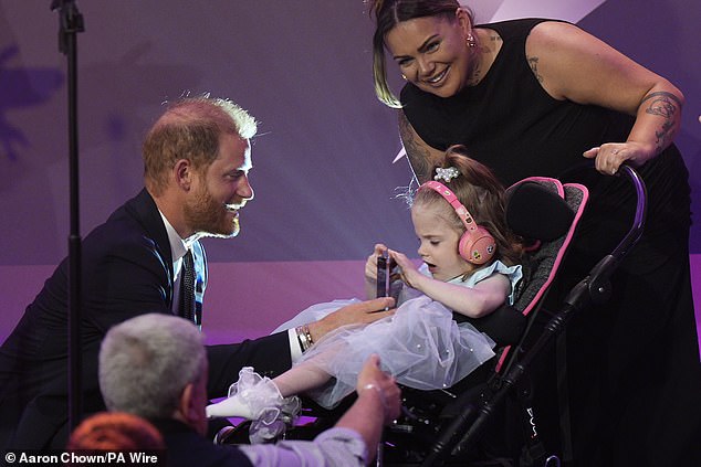 Prince Harry presents the Inspirational Child 4-6 award to six-year-old Esmee Mcglinchey
