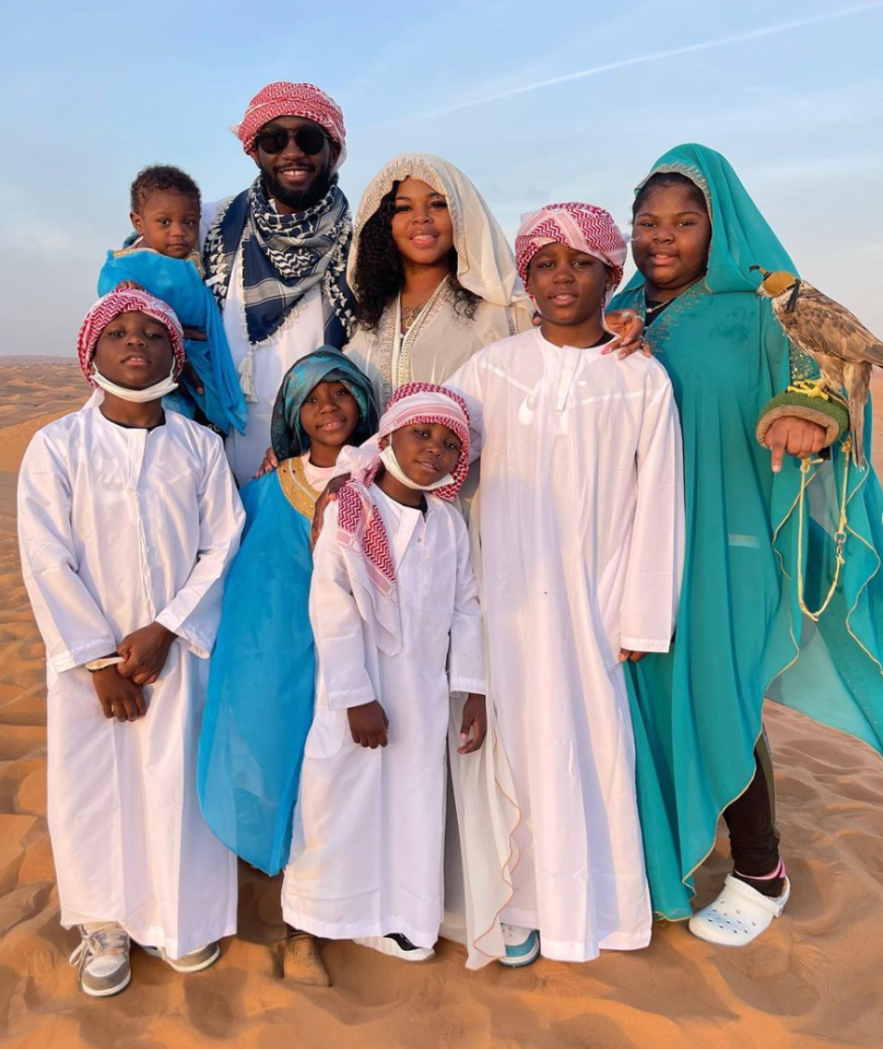 Family in desert with falcon.
