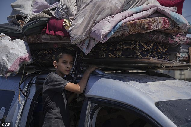 Displaced Palestinians fleeing northern Gaza carry their belongings along the coastal road toward southern Gaza, Tuesday, September 9, 2025, after the Israeli army issued evacuation orders from Gaza City