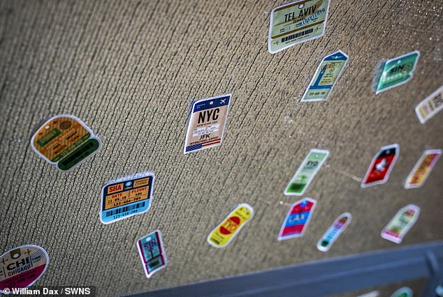 Travel stickers remain emblazoned against surfaces inside the converted plane