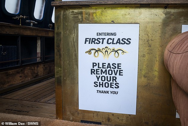 A first class section of the plane carries an instruction for those stepping in