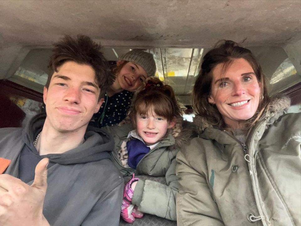 Selfie of a family of four in a vehicle.