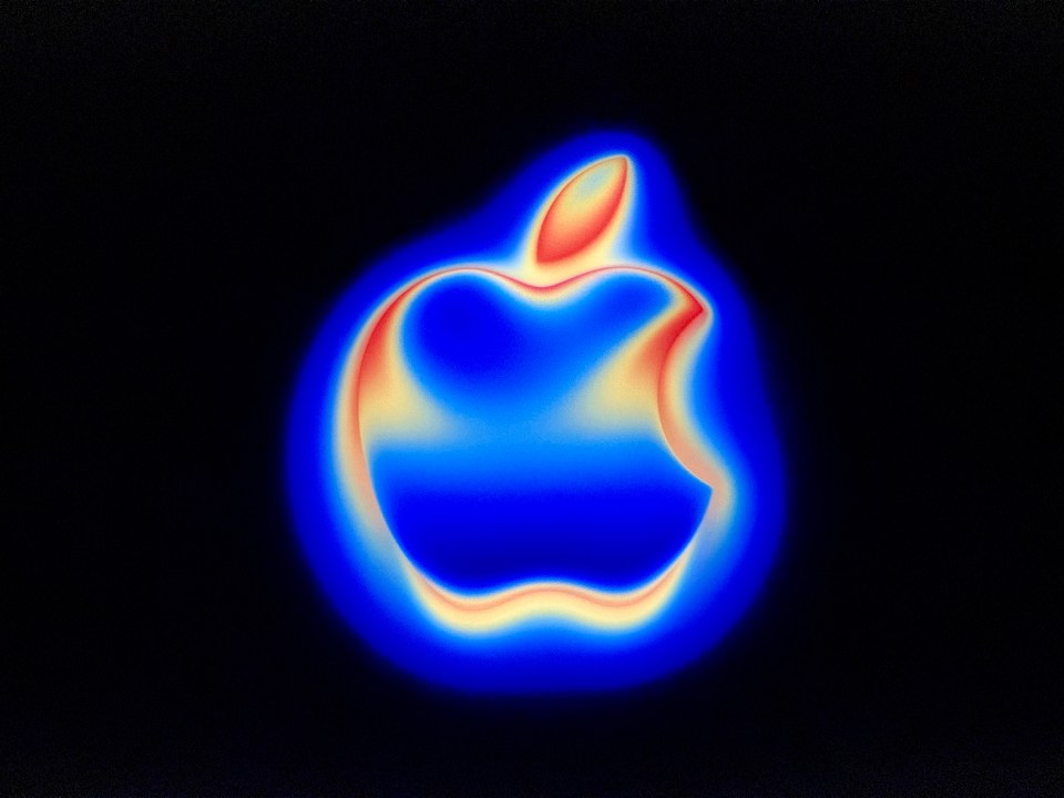 Apple logo in blue and red hues.