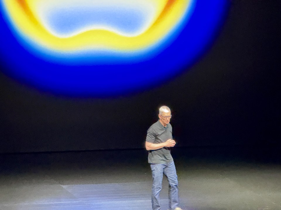 Man in glasses giving a presentation on stage.