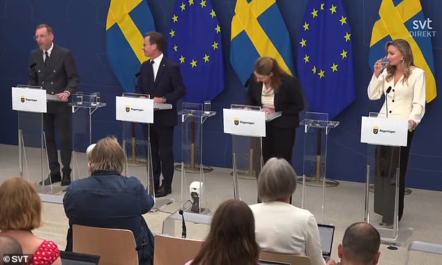 Footage show Elisabet Lann slowly falling forward as she is joined on stage by the PM and other officials