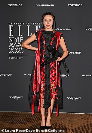 Bel Powley wore a black sleeveless midi dress with a red ribbon detail