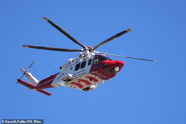 A coastguard emergency helicopter was pictured flying above the area today